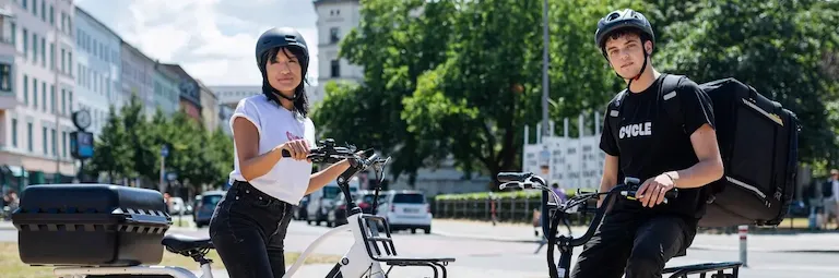 A man and a woman on cargo e-bikes