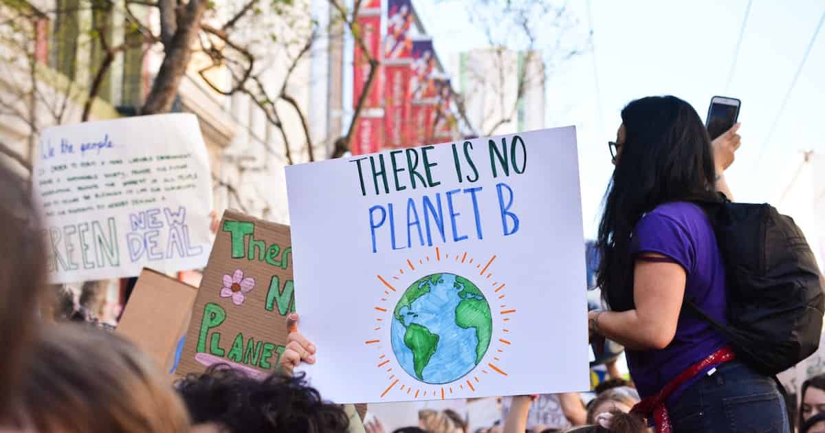 Protest with woman holding sign saying there is no Planet B