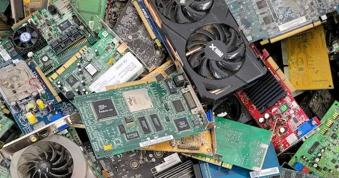 A pile of discarded circuit boards and computing equipment