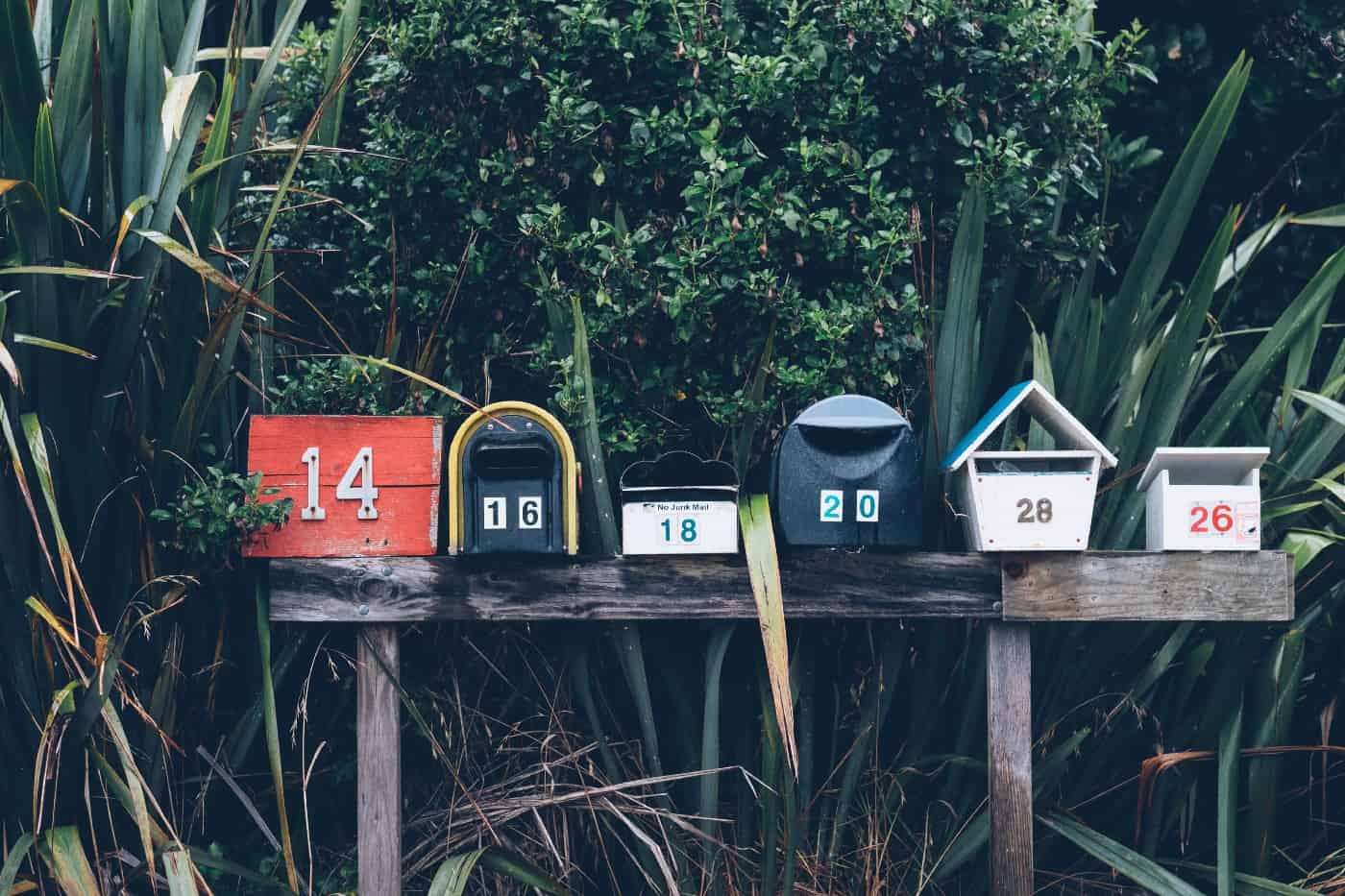 Six wooden mailboxes with different numbers