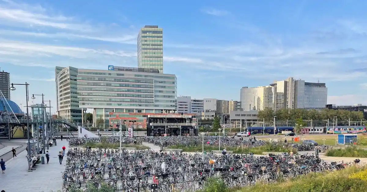 Bikes parked in from of a train station in Amsterdam